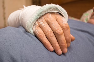 A man displays a bandage protecting a recent nursing home burn injury