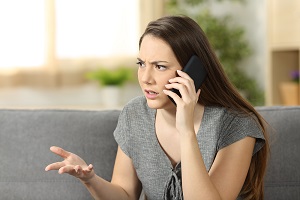 A worried mother calls on the phone to report potential daycare abuse