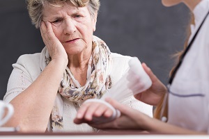 A nurse treats a woman's nursing home burn injury