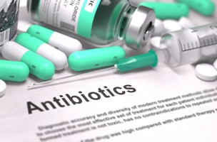 antibiotic pills and injection with informational text