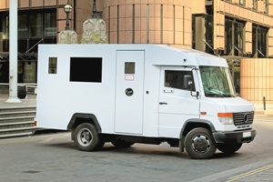 armored truck parked in front of building Gray & White Law