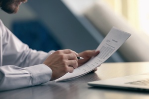 attorney reading legal documents Gray & White