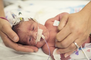 birth injury baby in nicu parent hands