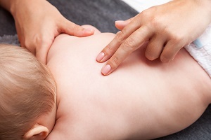 Assessing the spine of a newborn baby