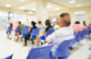 blurred image of people waiting in a hospital emergency room