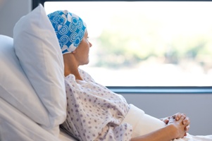 cancer patient in hospital bed looking out the window