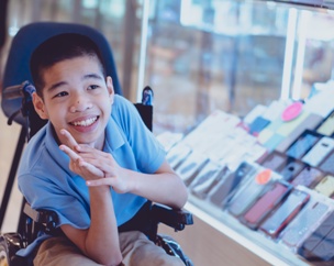 child with cerebral palsy smiling in wheelchair