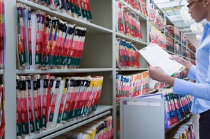 clerk checking medical records file evidence