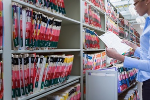 clerk checking medical records file evidence