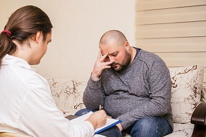 A social worker interviews a nursing home resident with intellectual disabilities