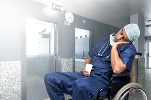 doctor asleep in hospital hallway wheelchair