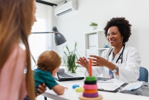 doctor evaluating baby's developmental milestones