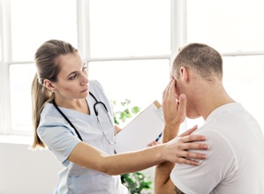 doctor examining patient with head injury