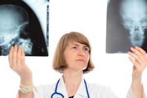 doctor examining x-rays of skull