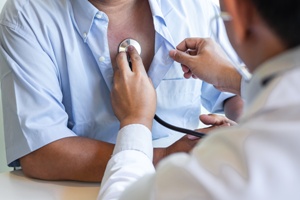 doctor listening to heart after radiation treatment