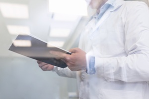 doctor with clipboard conducting inspection