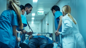 doctor and nurses rushing a patient to surgery