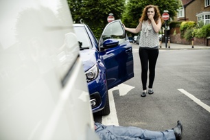 driver shocked to see injured pedestrian in front of her car