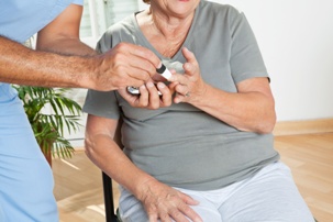 elderly person having blood glucose test