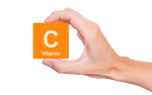 hand holding vitamin C block