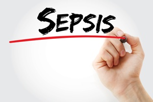 hand underlining the word sepsis with red pen