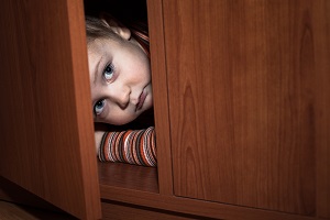 A child hides from abusive daycare providers