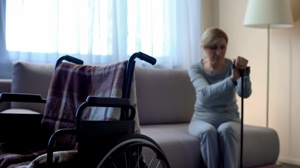 sad lonely elderly woman wheelchair in foreground