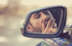 man yawning drowsy driving