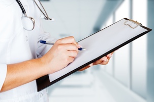 doctor writing on clipboard