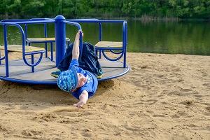 A boy suffers a merry-go-round accident while playing without proper supervision