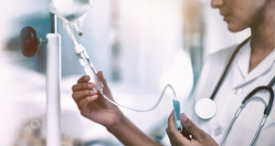 nurse adjusting dosage on an IV