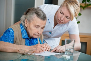 nurse helping elderly blind woman