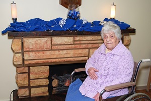 A nursing home resident sits dangerously close to the fireplace