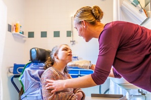 parent helping child with cerebral palsy