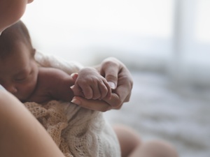 parent holding newborn baby