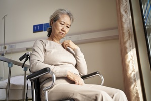 sad older woman in wheelchair nursing home neglect