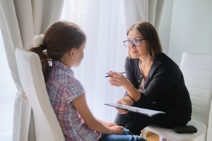 speech therapist working with young girl