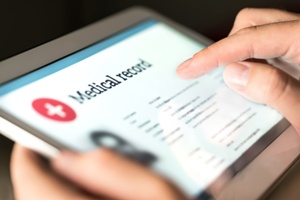 person viewing medical records on a tablet