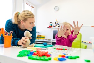 teacher and small child in play therapy session