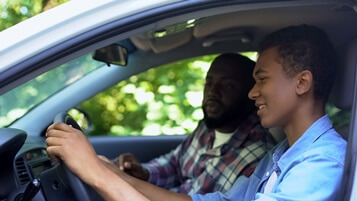 teen driver learning with parent in passenger seat