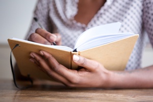 woman writing in journal