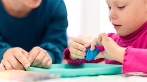 young child working with occupational therapist